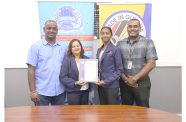 Aquafina Director Nalini Latchana receives the Made in Guyana Certificate from GNBS Technical Officer, Rachel Cecil