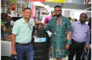 President Irfaan Ali at the booth with one of the water tanks