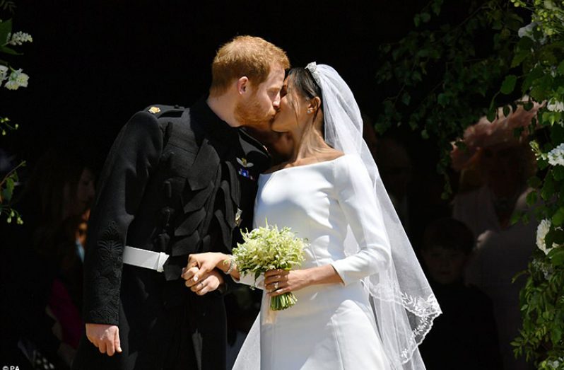 Sealed With A Kiss: Harry and Meghan sharing their first kiss as man and wife outside St George’s Chapel where they were married