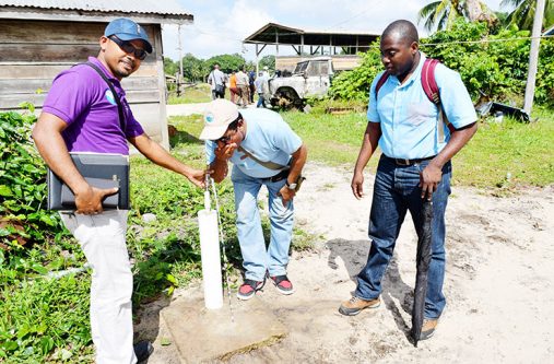 GWI officials testing the new water system [Cullen Bess-Nelson photo]