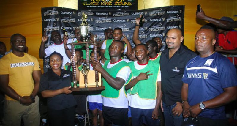 Champs! West Side Ballers captain Anthony Harding collects his team’s spoils.