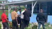 SOCU ranks escort former Minister Jordan to Plaisance Health Centre. 

(Travis Chase photo)