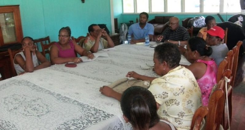 Minister Norman Whittaker interacts with members of the Kwakwani Interim Management Committee (IMC) during an outreach in the Berbice River on Saturday.