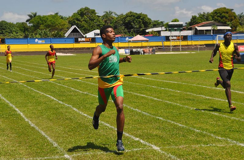 Linden's Daniel Williams takes a clear win in the Boys’ 400m yesterday at the Andre Kamperveen Stadium in Suriname. (Photos: Delano Williams)