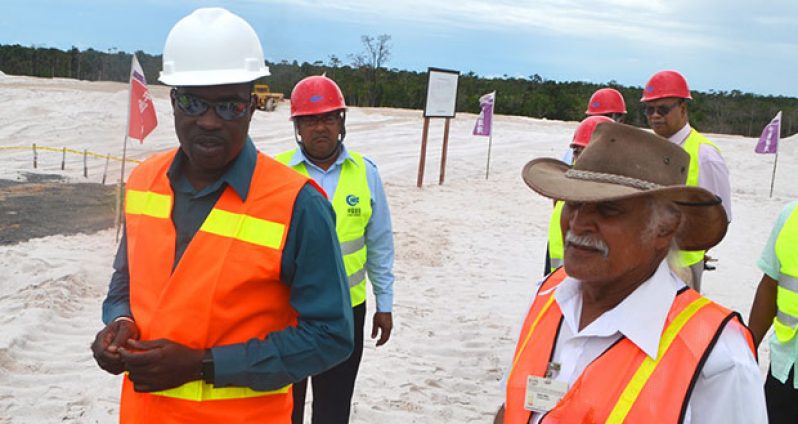 Willis listens as Minister Patterson briefs the media during a site-tour of the CJIA expansion project last Friday