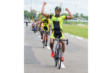 Geron Williams raises his hand in triumph even before crossing the finish line in yesterday’s GCF’s 71-mile road race around the outer circuit of the National Park (Delano Williams photos