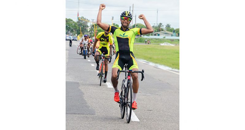 Geron Williams raises his hand in triumph even before crossing the finish line in yesterday’s GCF’s 71-mile road race around the outer circuit of the National Park (Delano Williams photos