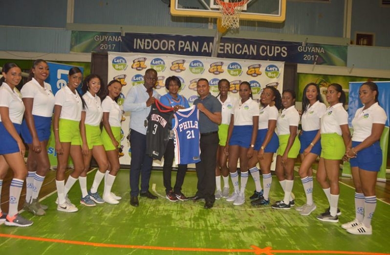 Winners of the NBA jerseys, Avinash Ramzan (right centre) and Kennard Copeland (left centre) pose with GLC General Manager Tracey Lewis (centre) and the Let’s Bet Sports models. (Adrian Narine photo)