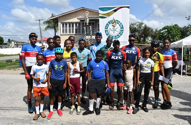 WINNERS ALL! The respective category and other winners of the WSUCC ‘One Guyana’ Bartica Cycling Classic pose with their silverware following Sunday afternoon’s presentation