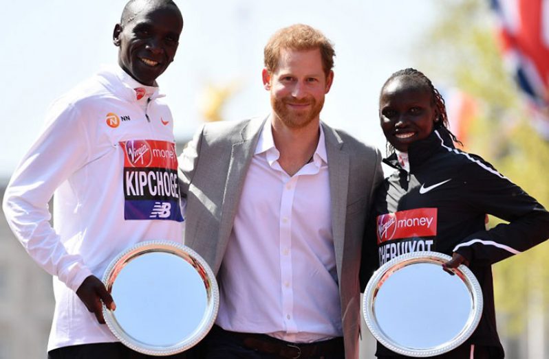 Prince Harry poses with Eliud Kipchoge of Kenya and Vivian Cheruiyot of Kenya after they received their prizes.(Reuters photo)