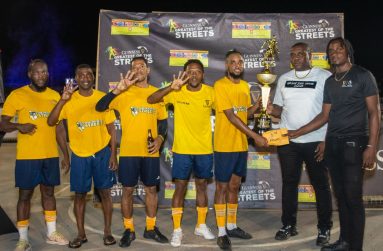 Swag Entertainment’s Allan Halley collects cash and a trophy from Banks DIH Linden Branch Manager Sean Grant (second right) and Sales Supervisor Omari Gordon (right).