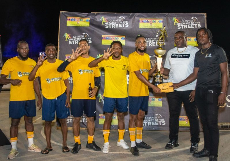 Swag Entertainment’s Allan Halley collects cash and a trophy from Banks DIH Linden Branch Manager Sean Grant (second right) and Sales Supervisor Omari Gordon (right).
