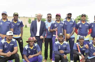 Vice-president Bharrat Jagdeo poses with members of the winning Cambridge team