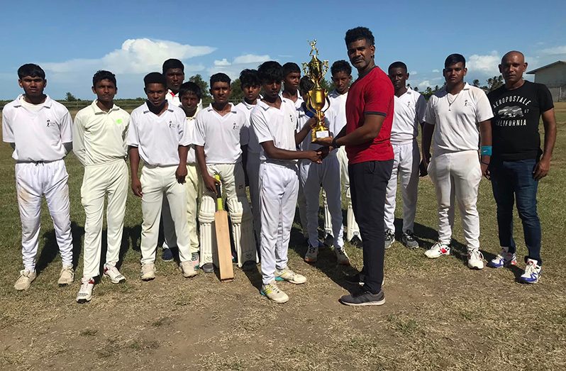 LCSS captain Damion Cecil receives the winner’s trophy from Anand Ramdial of ARMCO Ltd