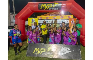 Waramuri Primary collecting the winners trophy from MVP Sports’ Ian Ramdeo