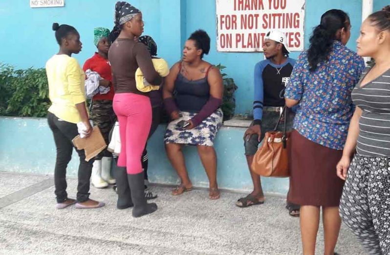 Affected staff outside a private hospital in the city.