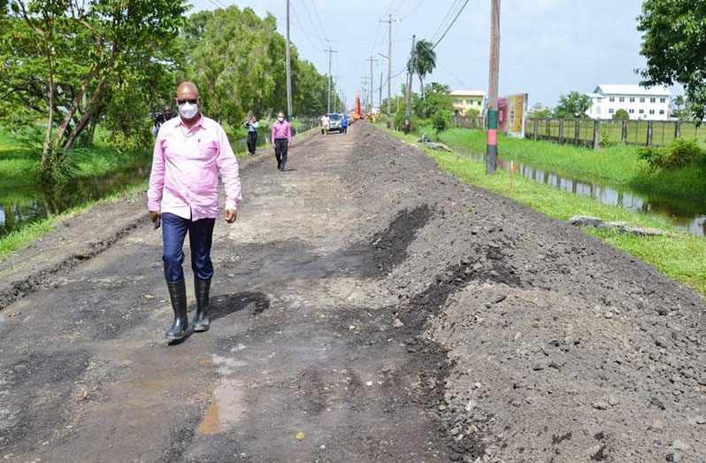 Minister of Public Works, Juan Edghill, inspecting works on the road at Thomas Lands (Public Works Ministry photo)