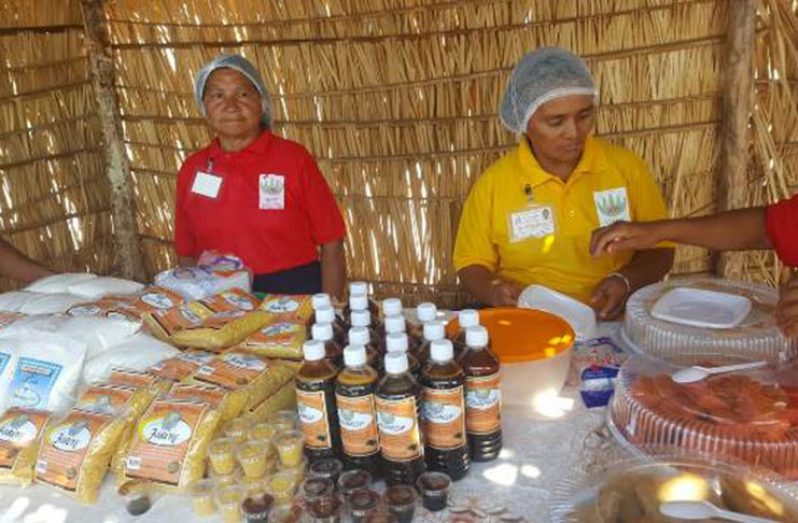 Two members of the Wowetta Women’s Agro-processers group showcasing their products
