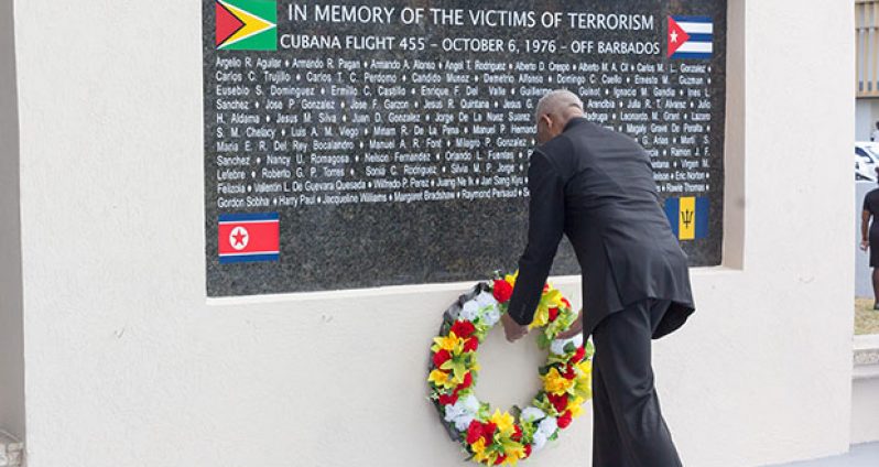 President David Granger lays a wreath at the monument erected at the Turkeyen Campus to remember the victims of the October 1976 terrorist attack