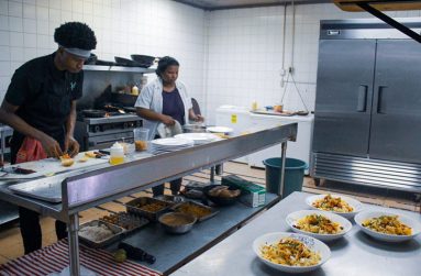 Chef Alicia Browne and her younger helper cooking in the kitchen at Xie Xie