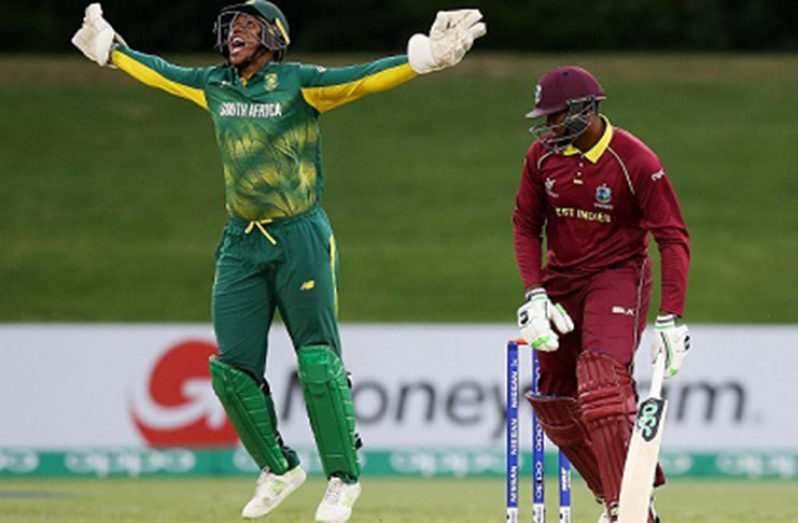 West Indies batsman Bhaskar Yadram falls to a catch at the wicket and Wandile Makwetu celebrates. (Photo courtesy ICC Media)