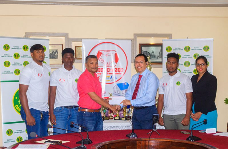 Director and Fire Manager at Hand-in-Hand Insurance, Howard Cox (third right), hands over the sponsorship cheque to secretary of the GCB, Anand Sanasie. Also sharing the moment are (Bhaskar Yadram, Joshua Persaud, Ashmead Nedd and a staff member from the insurance company. (Delano Williams photo)
