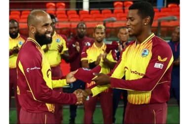 Yannic Cariah (left) receives his T20 cap from fellow spinner Akeal Hosein (Photo: Getty Images)