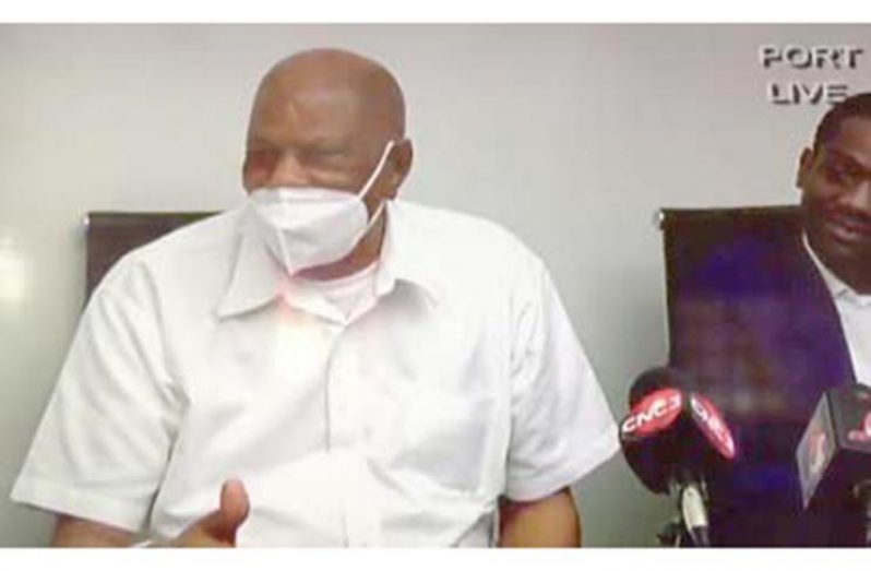 Yasin Abu Bakr (in white) flanked by attorney Christon Williams at news conference (CMC Photo)