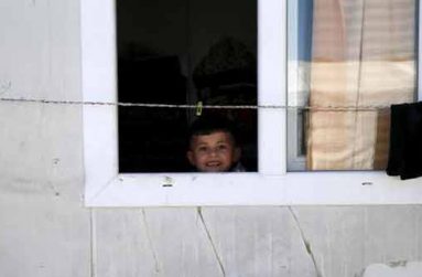 (Yazidi boy Emad, 5, looks out of his family’s home at a refugee camp near the northern Iraqi city of Duhok April 19, 2016. (REUTERS/Ahmed Jadallah)