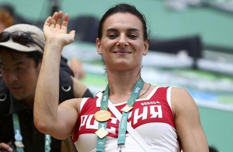 Yelena Isinbayeva of Russia waves from the tribune. (REUTERS/Michael Dalder)