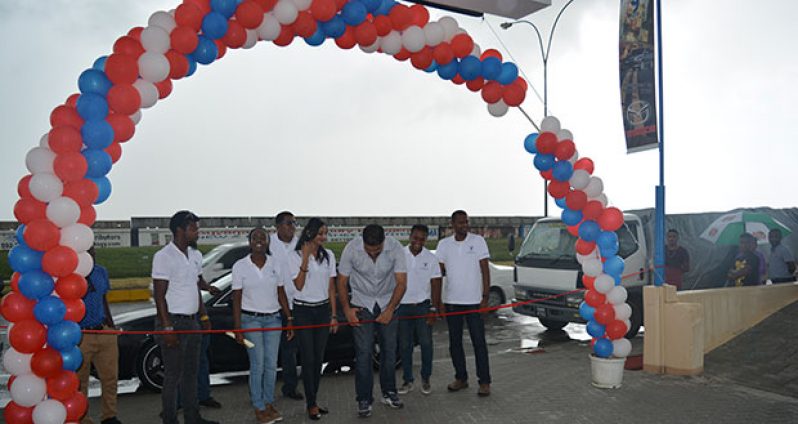 Yokohama Trading General Manager Deepak Balradj, flanked by staff, cuts the ribbon to officially open the new base in Guyana