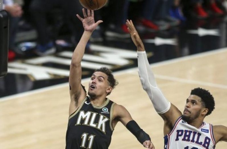 Trae Young (left) tied his career-high of 18 assists, to go with a game-high 25 points for the Hawks.