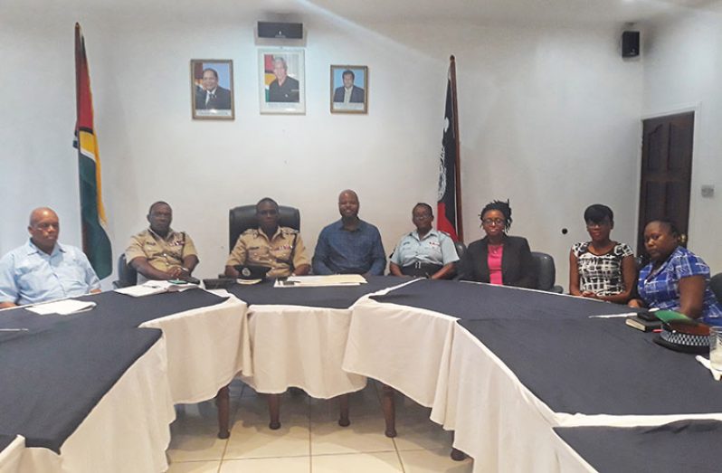 Commissioner of Police Leslie James (third from left) flanked by his deputies and Youth Challenge Guyana representatives during the meeting