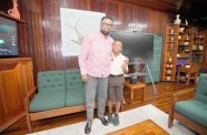 President Dr Mohamed Irfaan Ali and ten-year-old Treyson Mahadeo share a photo-moment on Tuesday