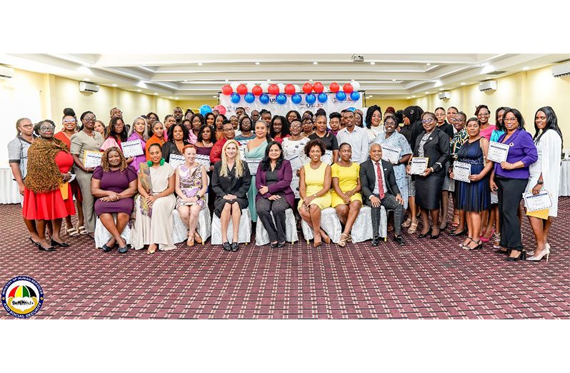 Seated from left to right: UK Deputy High Commissioner, Judy Omasan Kpogho; USAID Y-RIE Guyana Country Director, Tiffany Daniels; USAID Y-RIE Chief of Party, Phelps Feeley; United States Ambassador to Guyana and CARICOM, Nicole Theriot; Minister of Human Services and Social Security, Dr. Vindhya Persaud; USAID General Development Specialist, Chloe Noble; Training Facilitators Kaiesha Douglas-Perry and Lauristan Choy pose with social support officers (teachers, guidance counsellors, social service officers, probation officers, youth support officers) who completed capacity building.