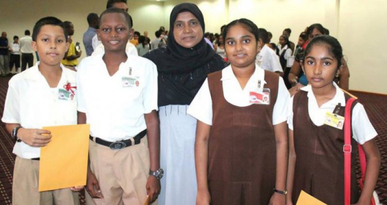 Zailmoon Samad, headteacher of the Leonora Primary School, with four of her five students who secured a place at Queen’s College this year. Teacher Samad is among 16 headteachers who have been approved to benefit from duty-free concessions