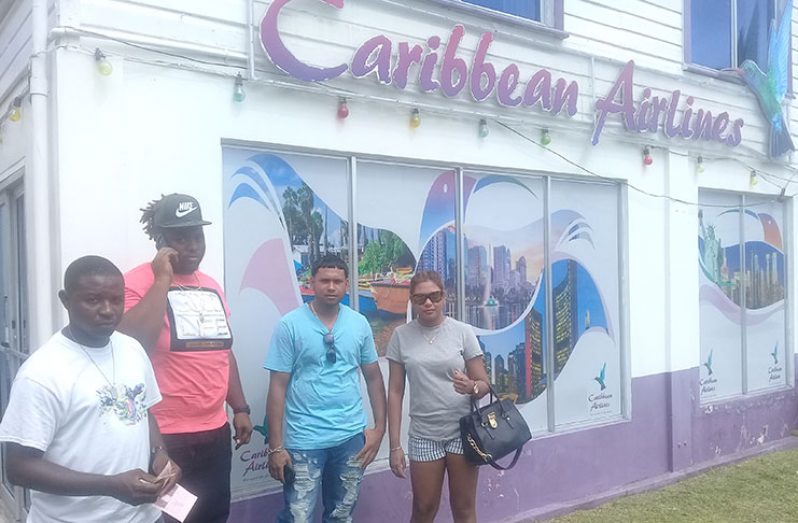 From right:  Nandani and Sudesh Hemnauth, Crail Taylor and his relative were among the many persons seeking answers at the CAL office on Monday