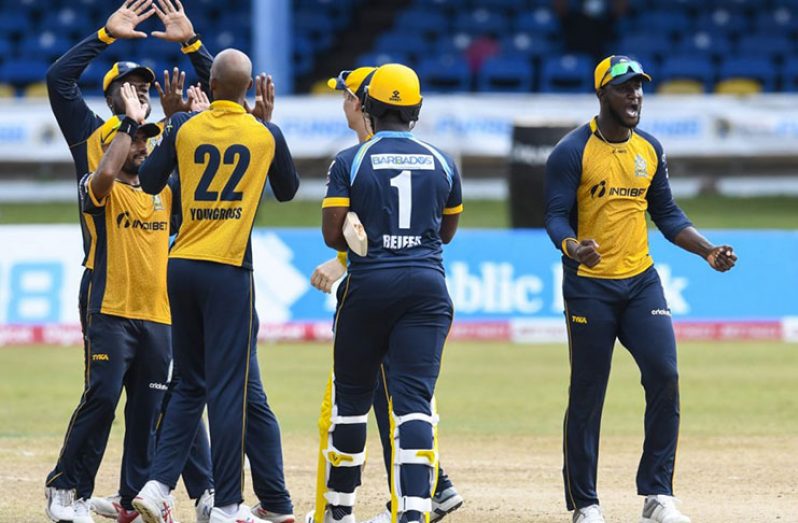 Darren Sammy, right, the St;Lucia Zouks captain celebrates the Hero Caribbean Premier League match against the Barbados Tridents at the Queen’s Park oval.(Ohot by Randy Brooks CPL t20 via Getty Images.