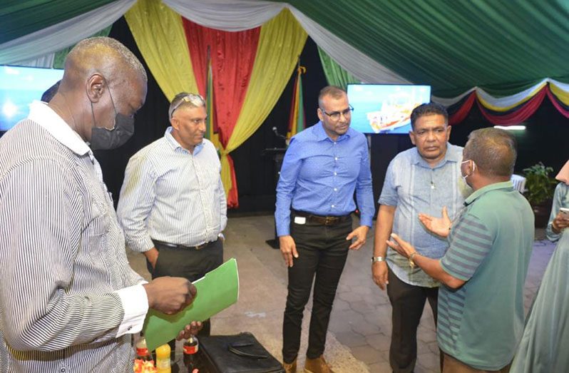 Foreign Secretary Robert Persaud (third left) and Agriculture Minister Zulfikar Mustapha (fourth left) meet with Guyanese in Suriname
