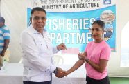 Agriculture Minister Zulfikar Mustapha hands over a cheque to a fisherwoman during Monday’s distribution exercise