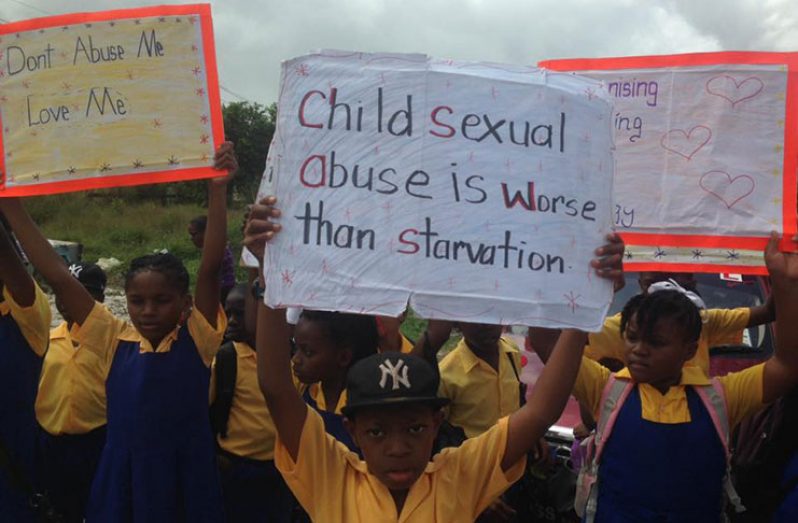 Children during the march against child abuse on Friday