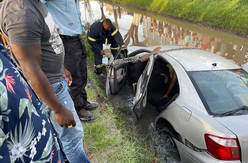 Firefighters rescuing passengers from the car which was stuck in the trench at Avenue of the Republic