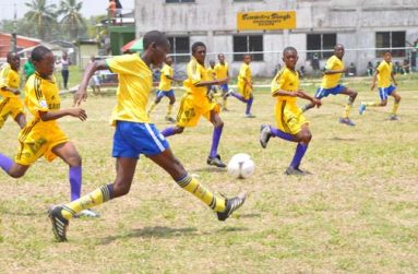 Grove Hi Tech double goal scorer Threvon Pluck (with ball) moves towards the Diamond United FC goal yesterday