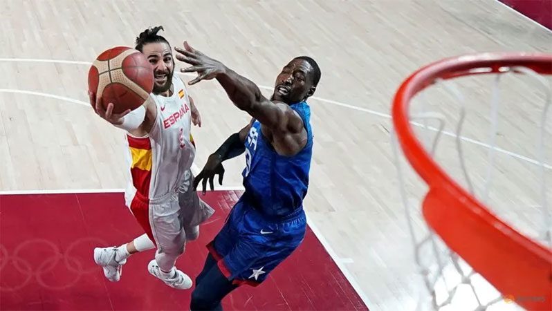 Ricky Rubio of Spain in action at the rim with Edrice Adebayo of the United States Tokyo 2020 Olympics Basketball, Men’s Quarterfinal v United States at Saitama Super Arena, Saitama, Japan, August 3, 2021 (Pool via REUTERS/Charlie)