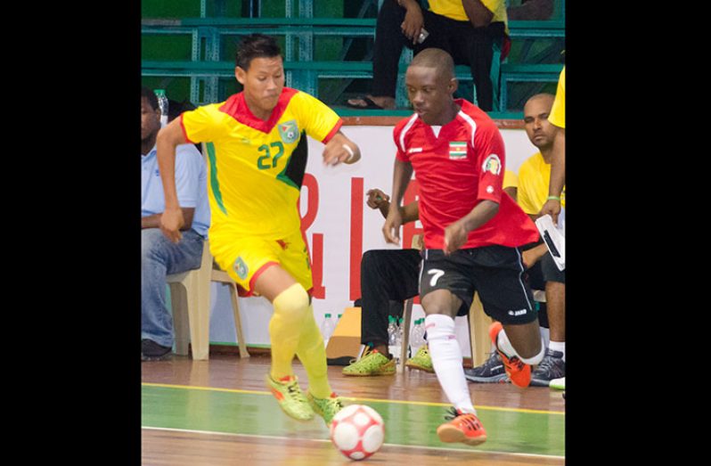 Part of the action in the Guyana /Suriname FUTSAL clash at the Cliff Anderson Sports Hall.