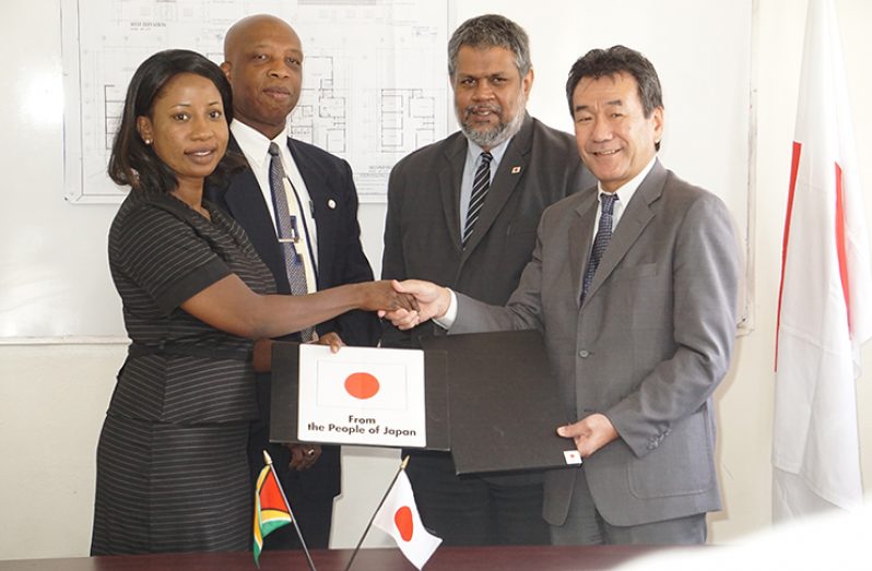 Chief Executive Officer of the Volunteer Youth Corps Inc. (VYC)Ms. Goldie Scott (left) and Japanese Ambassador, Tatsuo Hirayama (at right) display the signed document for the expansion of the Volunteer Youth Corps Youth Centre (VYCYC). With them are Mr Forbes July, Director of Department of International Cooperation, Ministry of Foreign Affairs (second Left) and Mr. Kashir Khan, Honorary Consul General for Japan in Guyana (second from right)