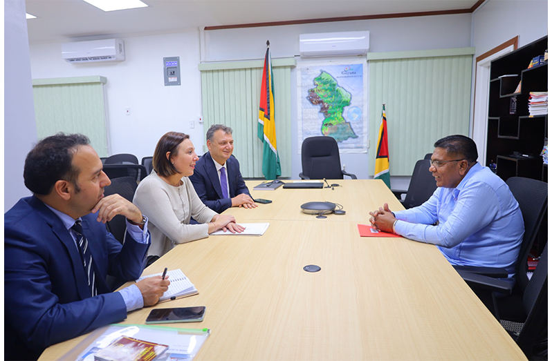 AGRICULTURE Minister Zulfikar Mustapha on Thursday received a courtesy call from the newly appointed non-resident Ambassador of the Republic of Italy to Guyana, Giuditta Giorgio. 
During the engagement, the officials discussed areas of mutual interest and opportunities for co-operation to further advance Guyana’s agricultural sector. Minister Mustapha highlighted Guyana’s ongoing transformation agenda in agriculture, with particular emphasis on investments to strengthen agro-processing and expand the use of technology across the sector. He also spoke about the government’s efforts to move Guyana beyond being primarily a producer of raw agricultural commodities to becoming a regional powerhouse in agro-processing and value-added production. The minister also outlined the significant advancements made in both traditional and non-traditional agricultural industries, noting that strategic investments and targeted policies continue to drive diversification, enhance productivity, and create new economic opportunities. The discussions also explored potential areas for collaboration that can support innovation, technology transfer, and the continued development of Guyana’s agricultural landscape. Also present during the meeting were Mr. Emanuele Di Girolamo, Commercial and Cultural Attaché at the Embassy of Italy in Panama, and Mr. Vittorio de Sanctis de Ferrari, President of the Italian–Panamanian Chamber of Commerce, Industry and Agriculture (MoA photo)