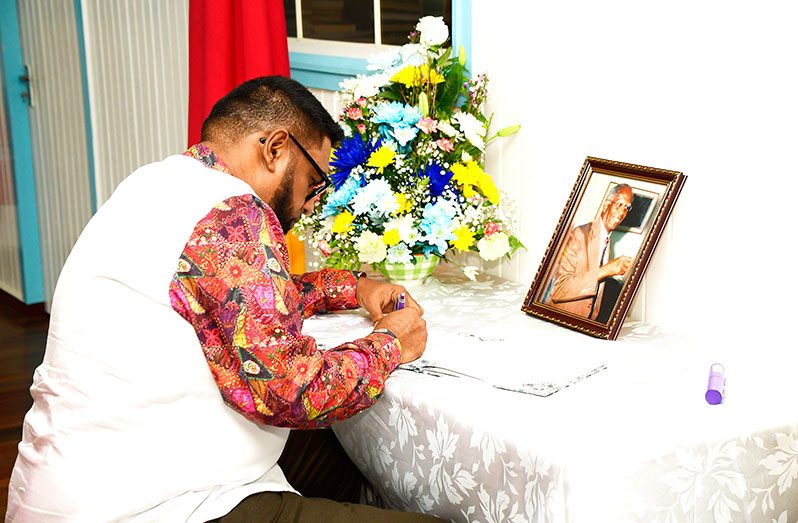 President Dr. Irfaan Ali signing the Book of Condolences for the late Senior Counsel Ashton Chase