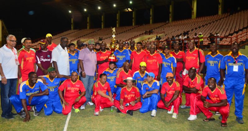 In this Adrian Narine photo  players from both teams pose with the President’s Xi winning trophy along with Minister Irfaan Ali and former Guyana and West Indies captain Clive Lloyd