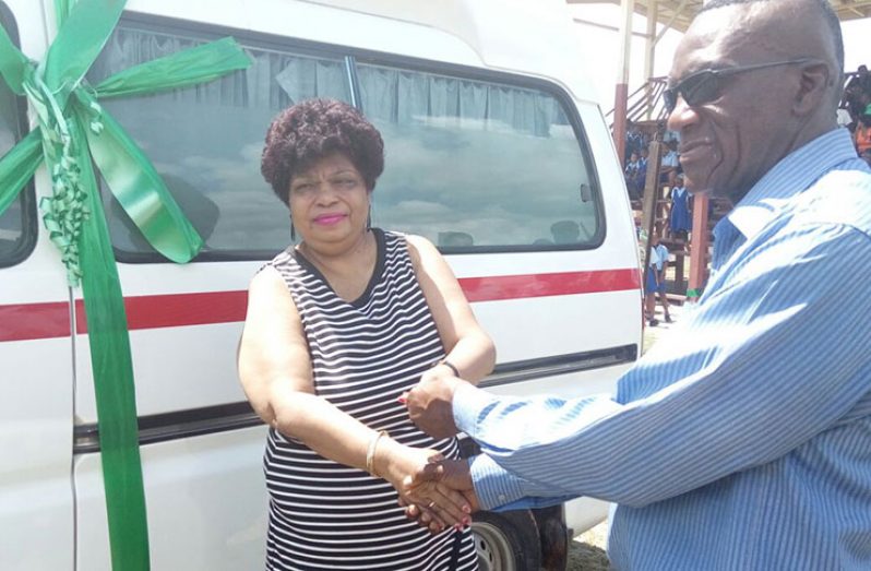 Minister of Social Cohesion, Amna Ally presenting the ambulance to Regional Chairman, Renis Morian